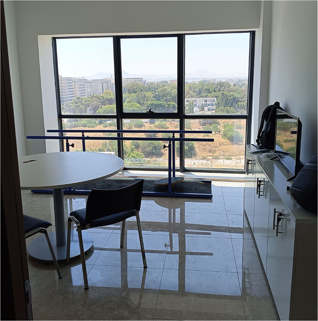 Cure Care Tunis clinic, training parallel bars beside a large window